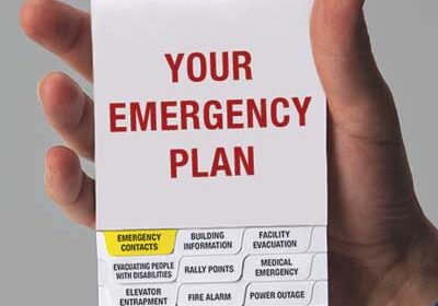 A person holding an emergency plan in their hand.
